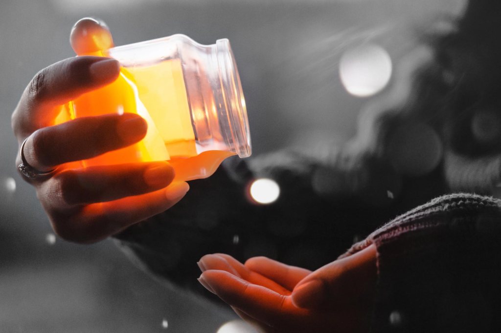 Honey being poured from a jar