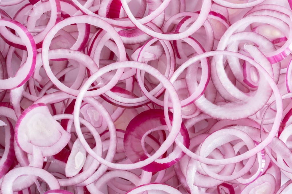 Many, many onion segments on top of one another, all mixed up. Drawing a parallel with customers and their journeys with your brand.